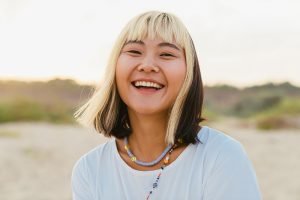 smiling woman with healthy oral microbiome