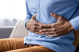 man with stomach pain and other gut symptoms
