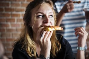 woman eating pizza