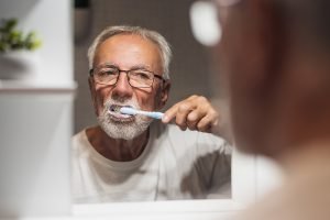 man brushing his teeth