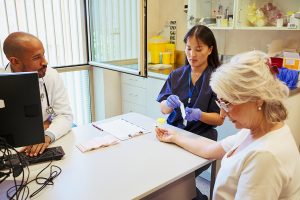 woman getting a blood test with doctor