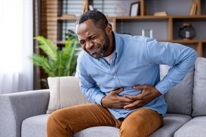 man with stomach pain from colon cancer